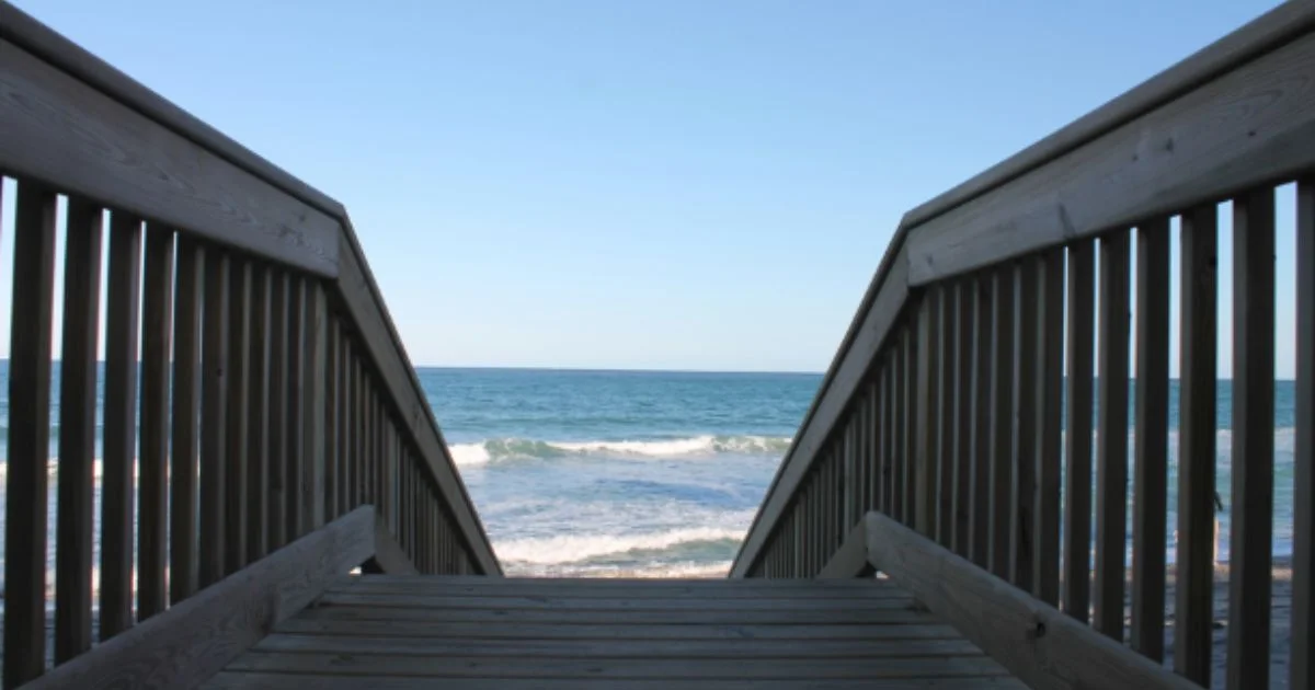 Wooden walkway leading to the ocean.